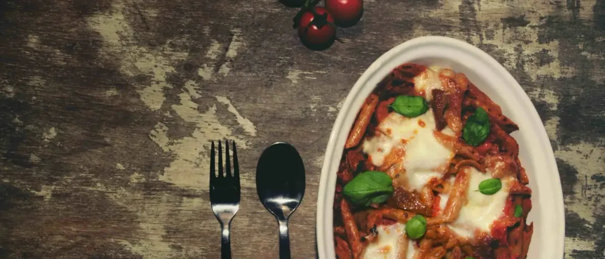 Mouth watering vegetarian pasta bake with rich tomato sauce and cheese toppings
